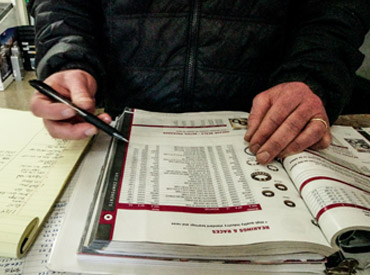 Person writing in the RV service appointment book