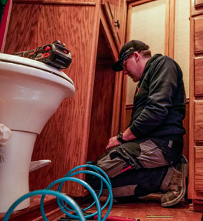 Action RV technician repairing an RV